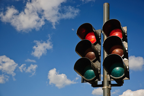 A couple of red traffic lights against a blue sky Traffic Lights